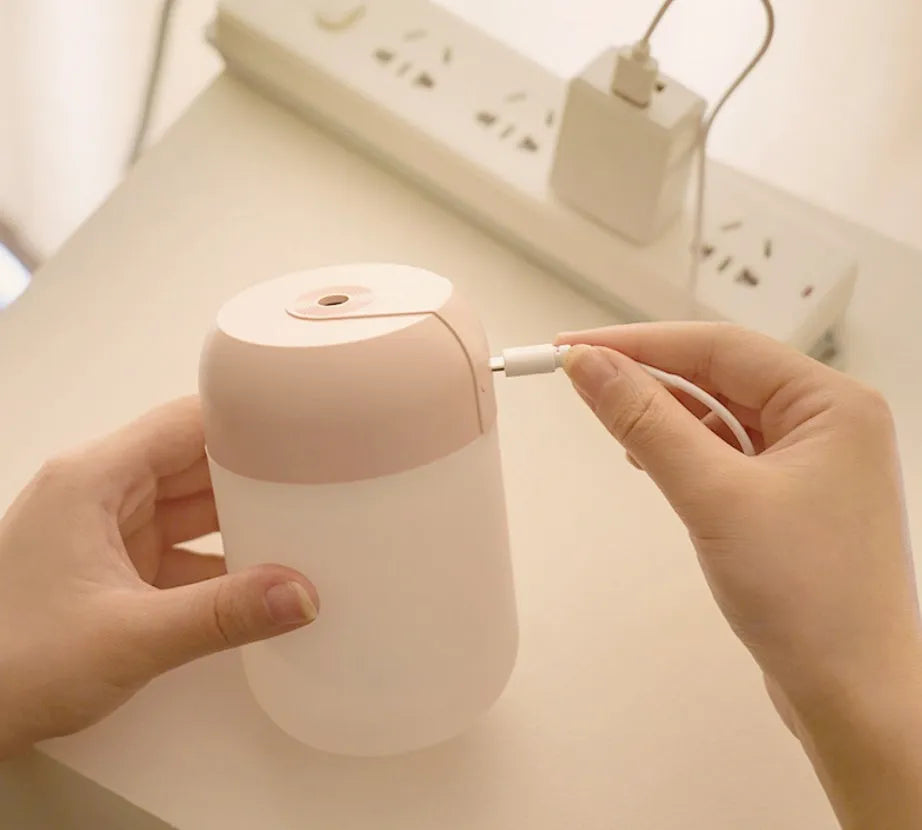 White cylindrical USB-powered mini humidifier with aromatherapy function on desk