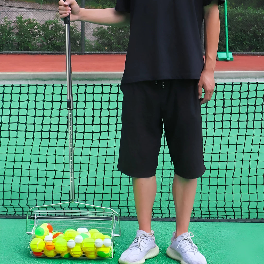 Stainless steel roller tennis ball picker with handle on a court