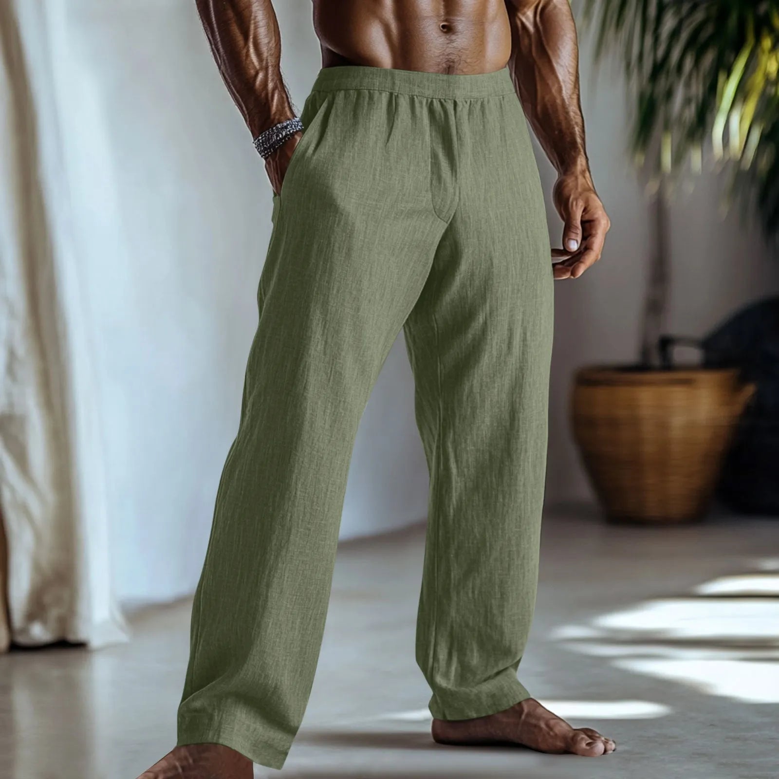 Straight leg cotton linen trousers in light apricot colour on a hanger.