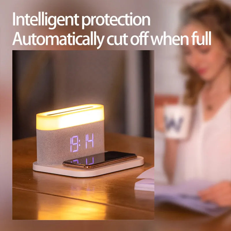 Mini black and white desk lamp with integrated wireless charging pad and clock display.