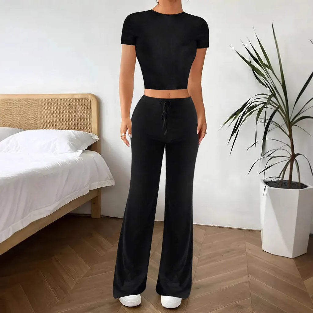 Women's black polyester trouser and T-shirt co-ord set showing complete outfit