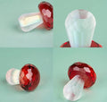 Colourful geometric crystal mushroom decoration in transparent, green, red, or yellow on a white background.