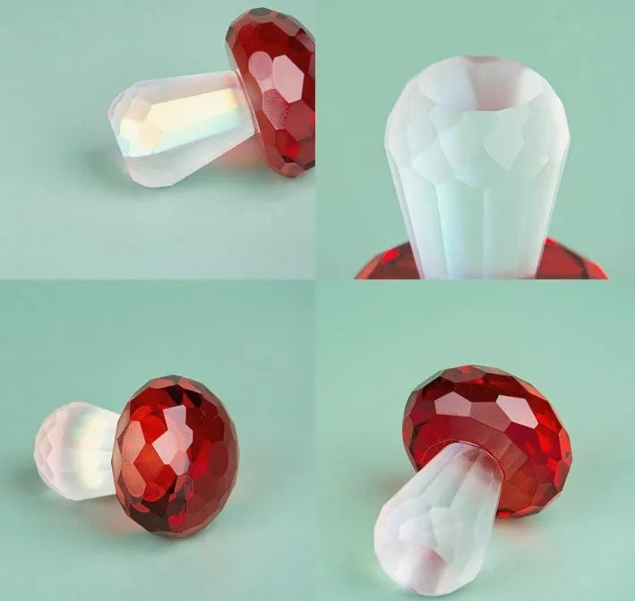 Colourful geometric crystal mushroom decoration in transparent, green, red, or yellow on a white background.