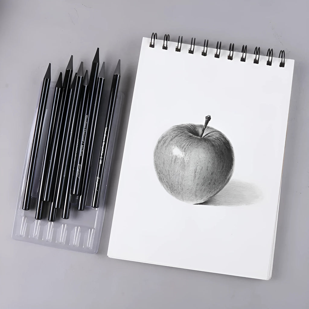 Set of nine wooden artist pencils including graphite and carbonized types on suction card packaging