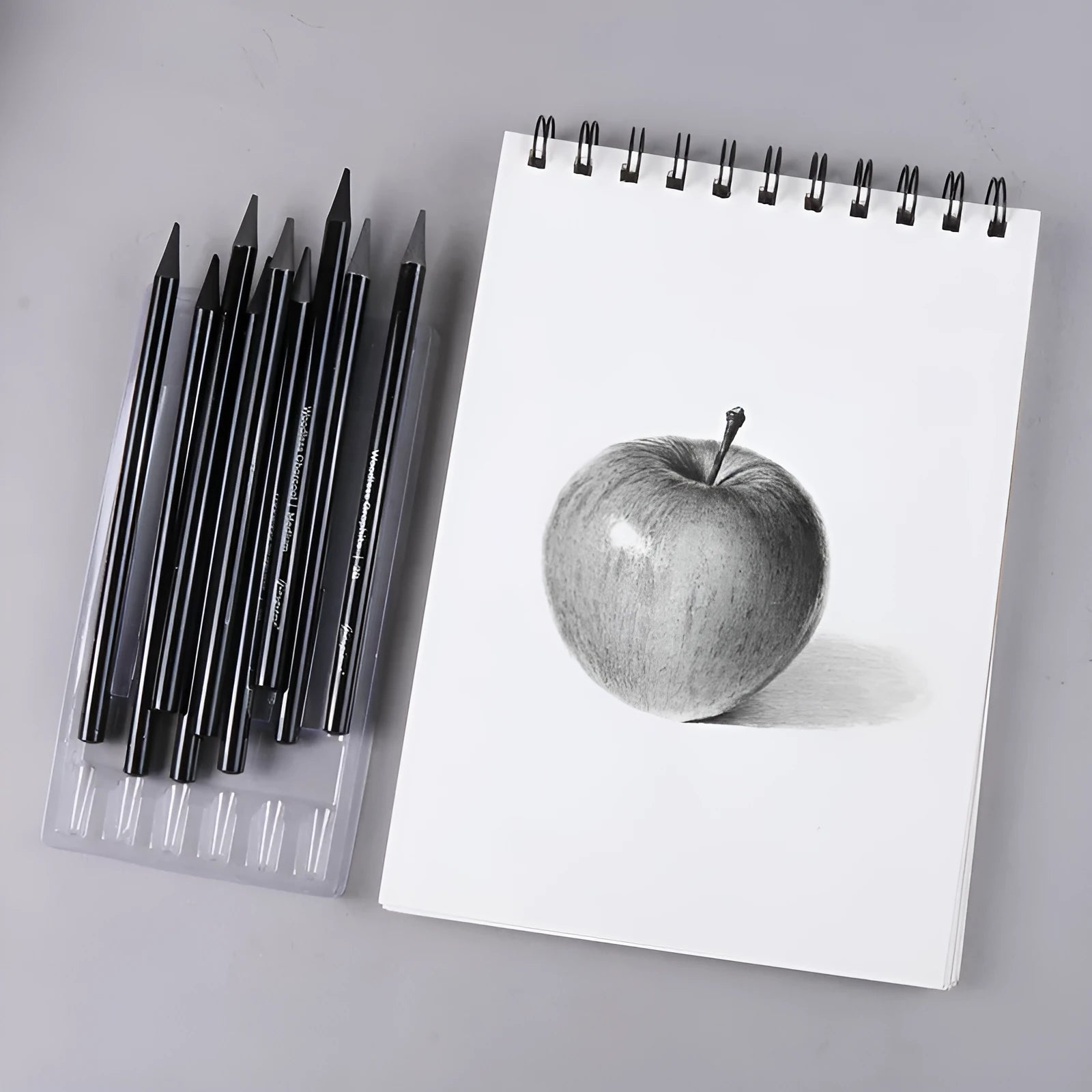 Set of nine wooden artist pencils including graphite and carbonized types on suction card packaging
