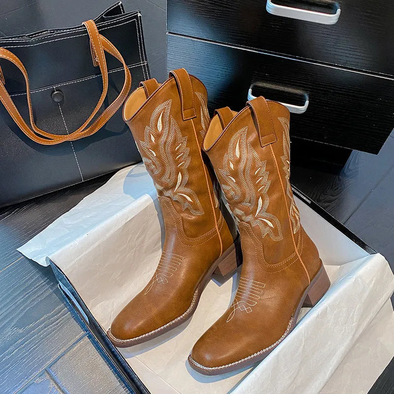 Brown women's mid-calf embroidered Martin boots with a leather lining and low rubber heel.