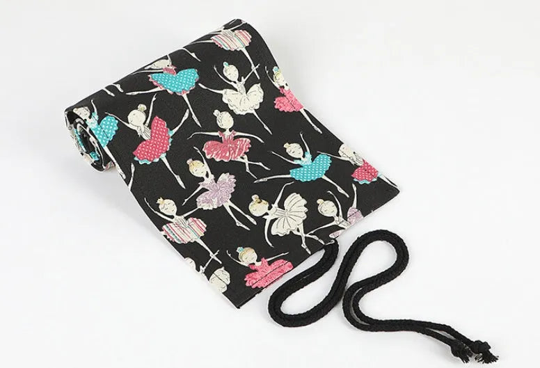 Square canvas rolling pencil case with ballet girl print, unfurled to show multiple pencil slots.