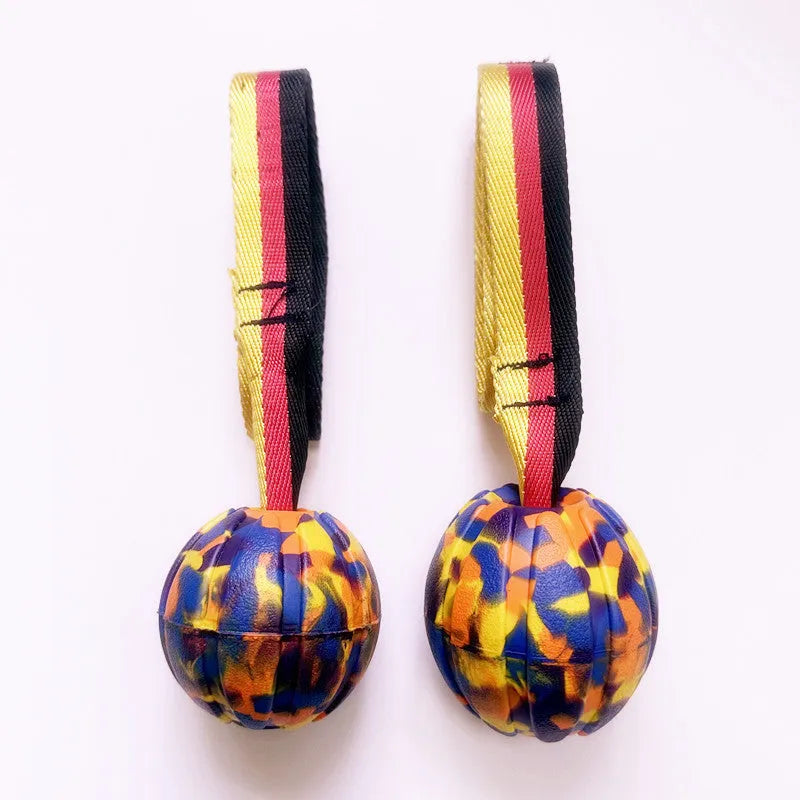 Floating EVA pet training ball in camouflage or yellow colours with attached string, shown in 6.5cm, 7cm, and 9cm diameter sizes