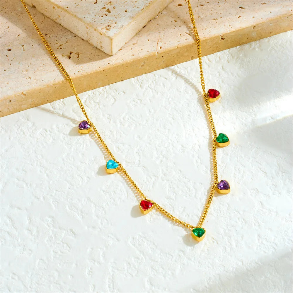 Gold heart pendant necklace on a stainless steel chain with adjustable length.