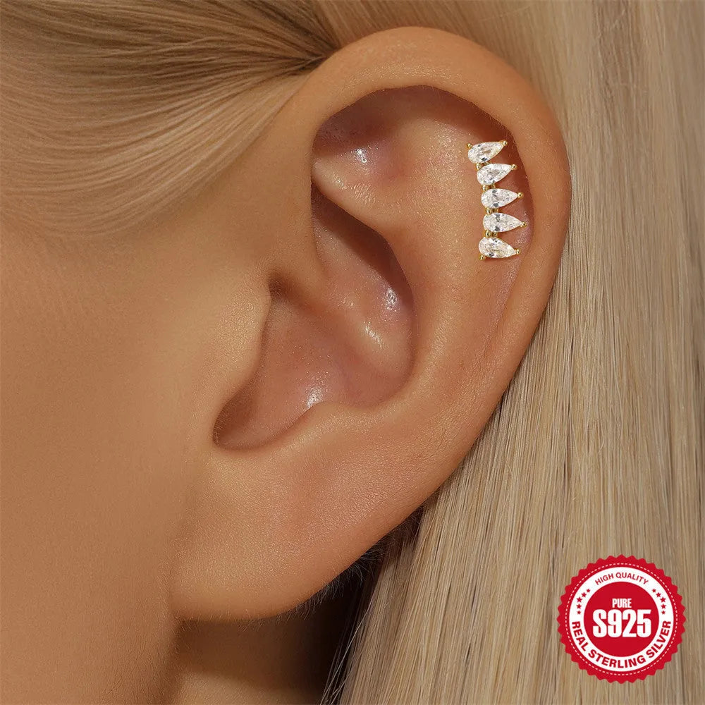 S925 sterling silver geometric moon and star earrings with diamond detail on a gold tone background.