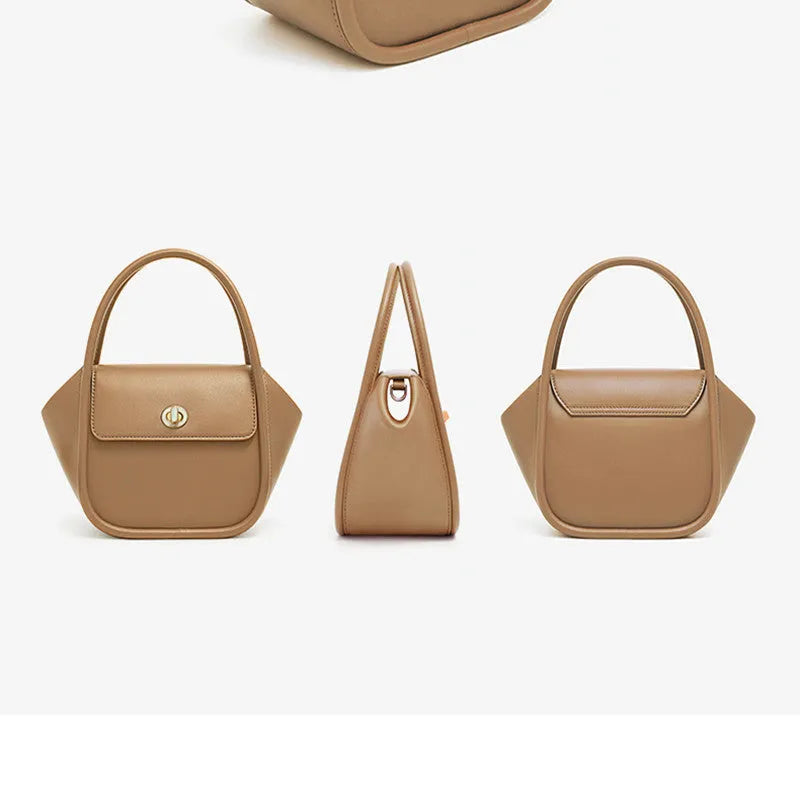 Brown leather wing-shaped tote bag with a buckle detail and latch closure, shown with a single cross-body strap.