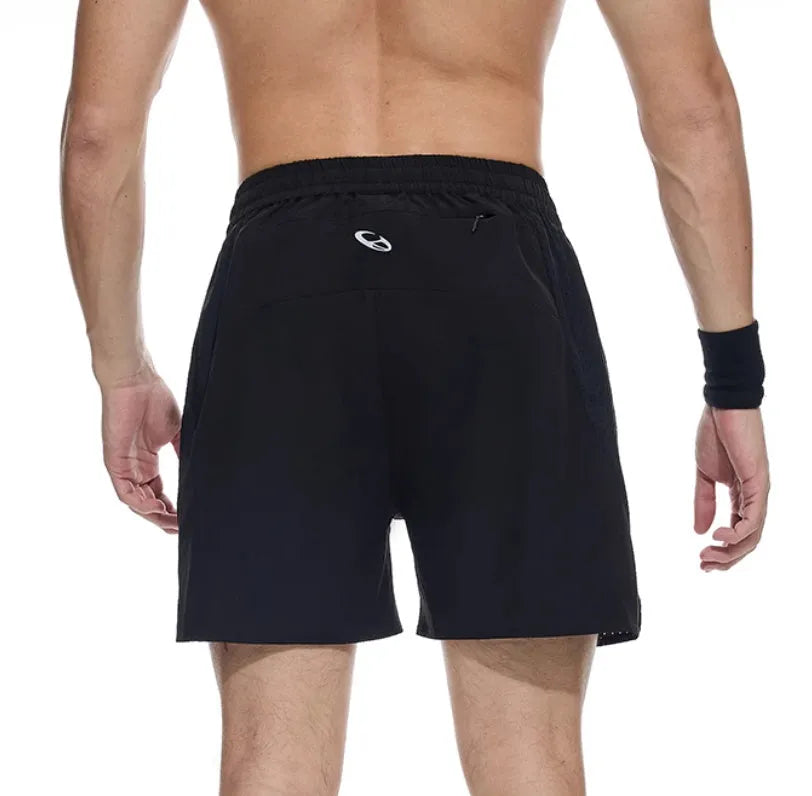 Close-up of black four-point stretch running shorts showing laser stitching detail on spandex fabric.