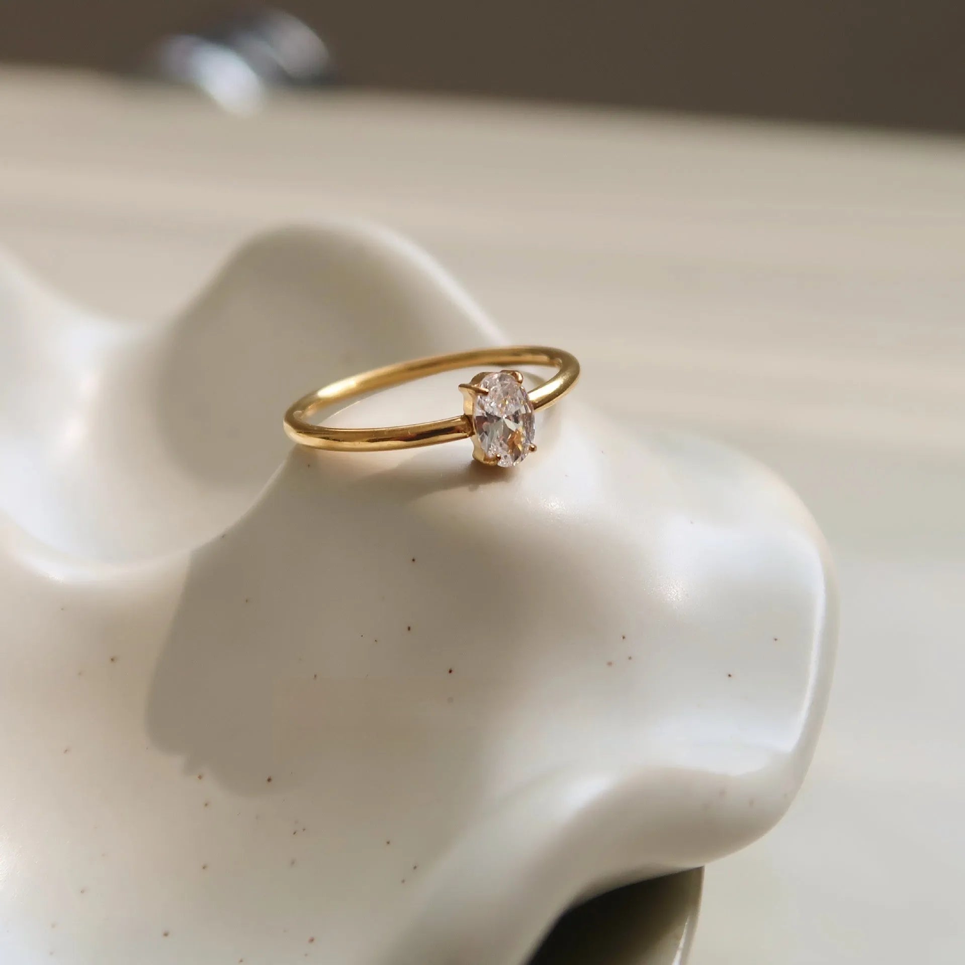 Golden heart-shaped stainless steel ring with electroplated finish shown in sizes 6, 7, and 8