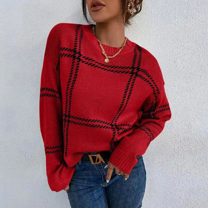 Women's loose-fit plaid sweater with apricot, black, beige, red, and green colour-block stripes.