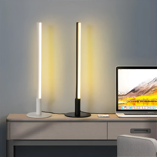 Tall, cylindrical black aluminium alloy retro atmosphere lamp on a table.