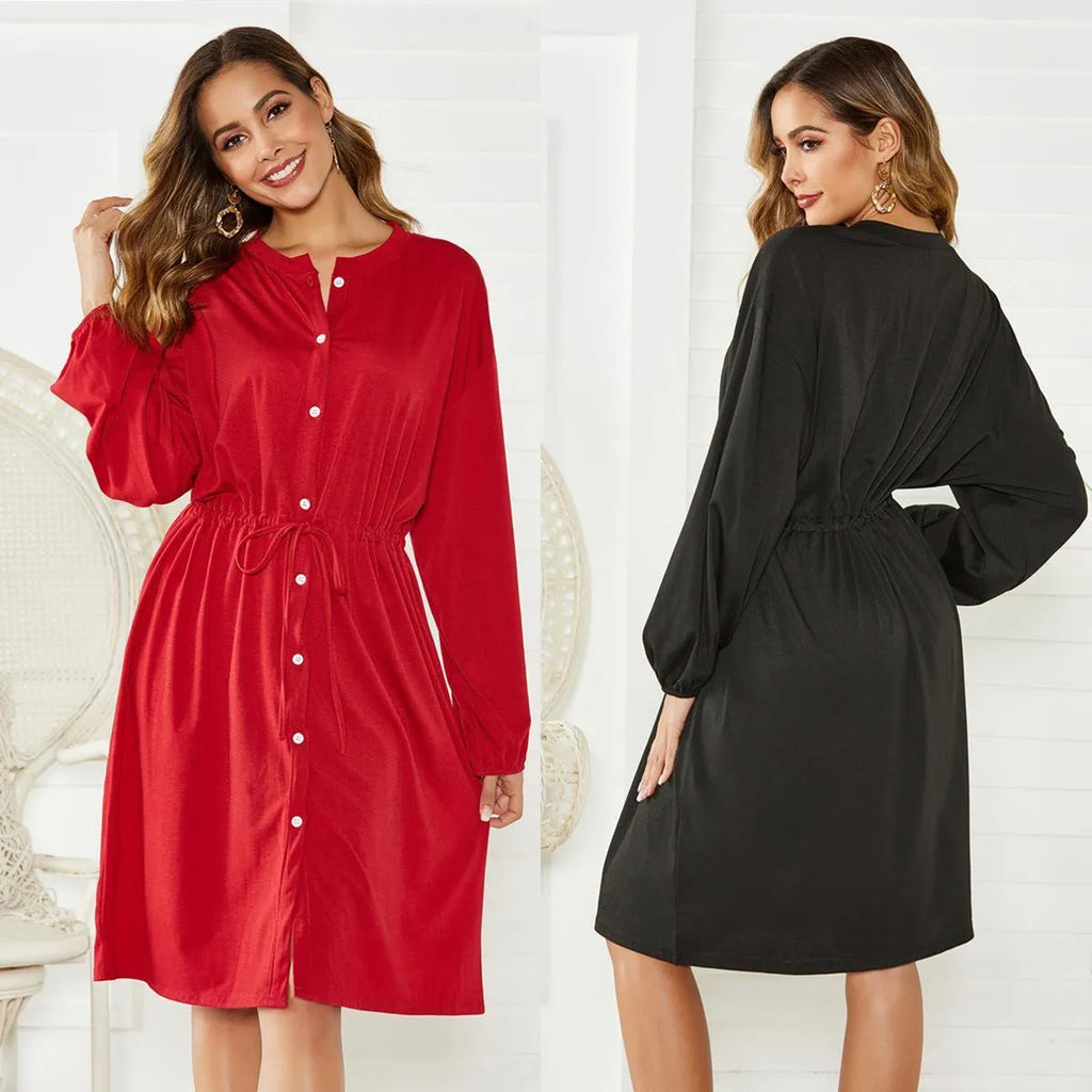 A black women's A-line midi dress with an elastic waist, long sleeves with elastic cuffs, and a detachable cinched belt.