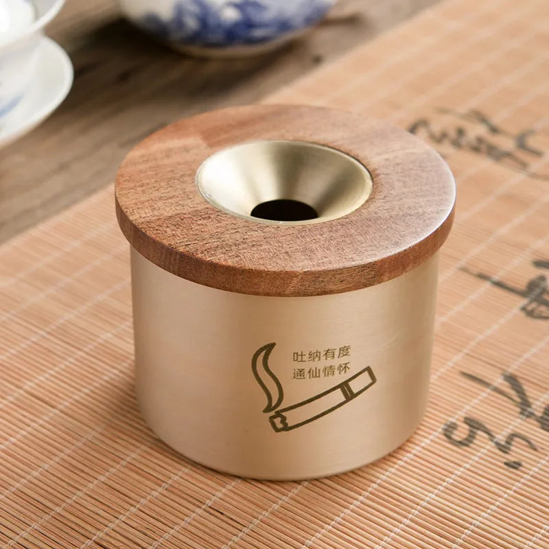 Retro brass ashtray with wooden lid showing centre hole design for ash collection