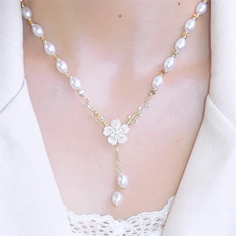 Pearl white alloy necklace with flower pearl charm and rose floral design elements on pearl chain