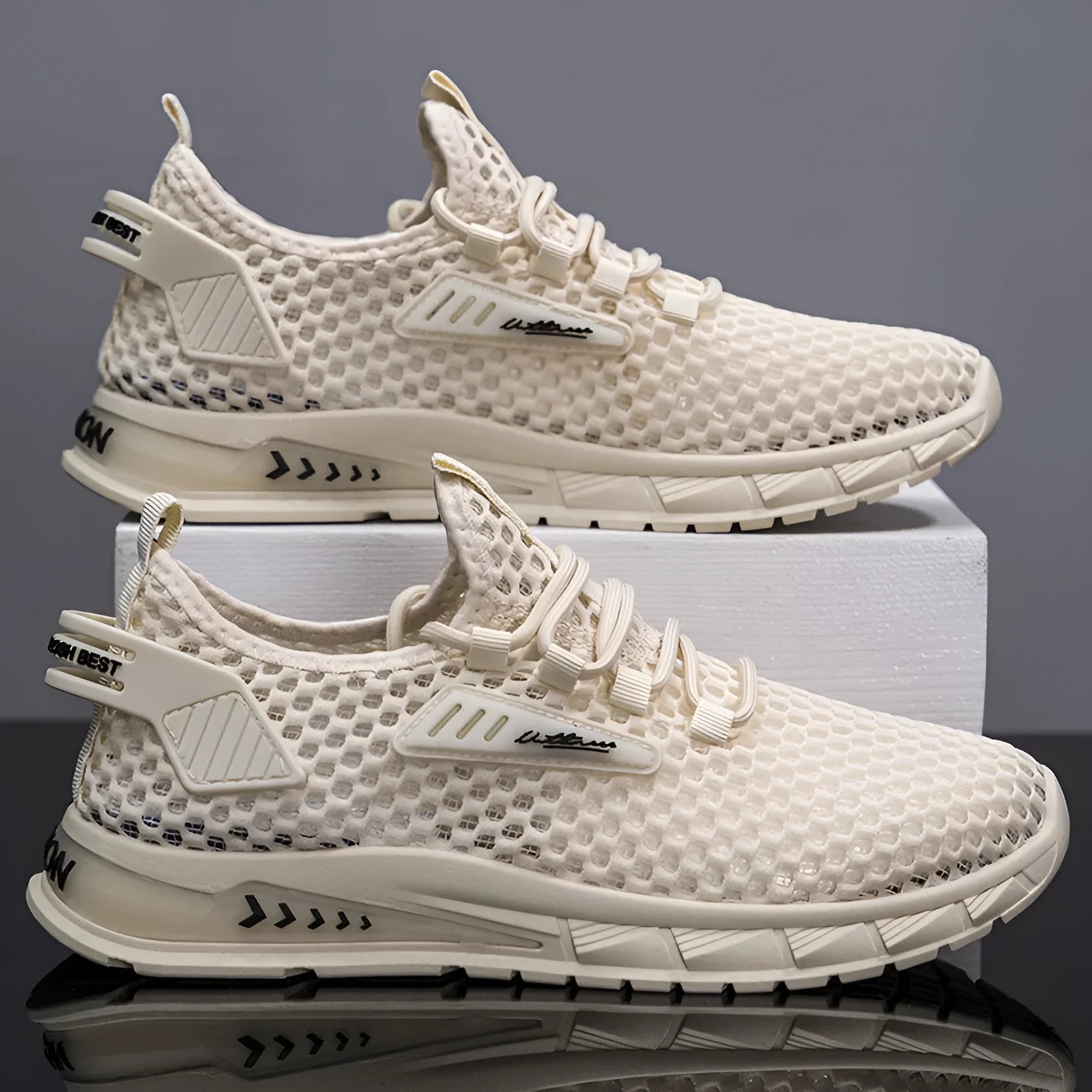 Men's beige casual sneakers with lace-up front, mesh panels, and a flat EVA sole.