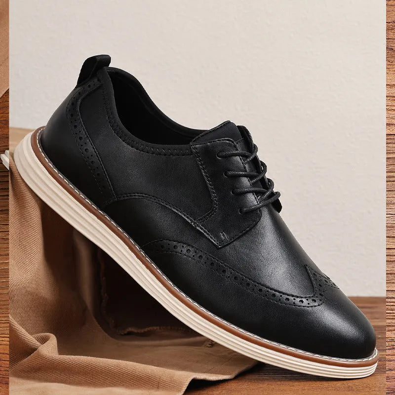 Men's black and brown slip-on casual shoes with round toe and carved detail on the upper.
