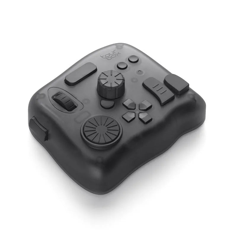 TourBox NEO black USB video editing controller auxiliary keyboard on a desk.