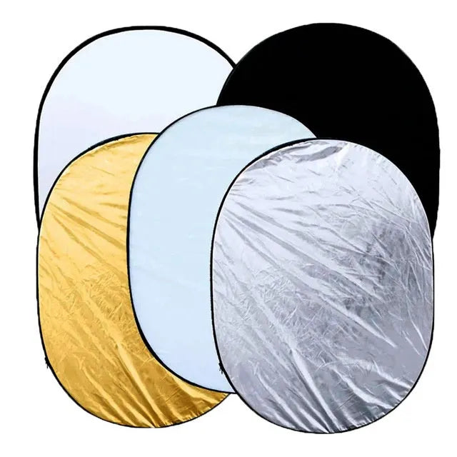 5-in-1 collapsible photography reflector showing gold, silver, white, black, and translucent surfaces folded beside carry bag