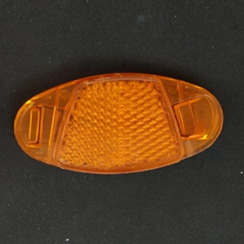 White and yellow plastic bicycle spoke reflectors for wheel safety visibility
