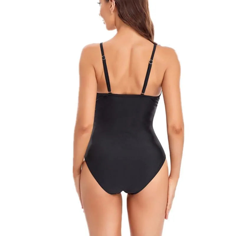 Black backless one-piece ladies swimsuit laid flat, showing solid colour and high elasticity fabric.