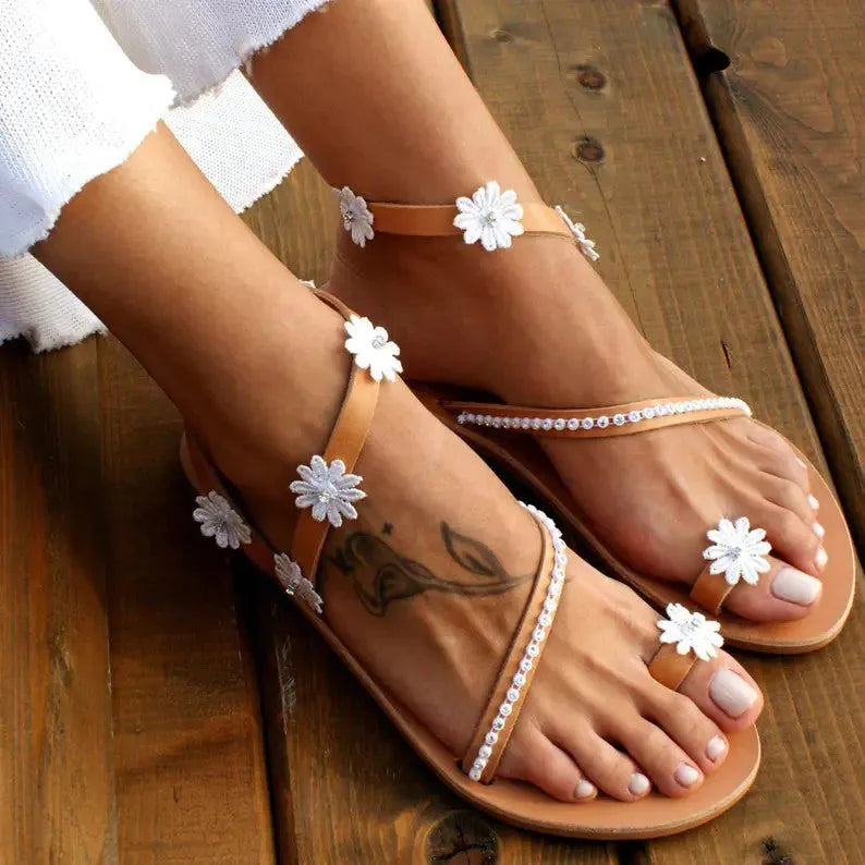 Brown ladies Roman sandals with flower pattern and flat rubber sole