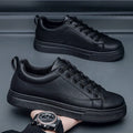 Men's low-top Korean-style casual sneakers in black on white colour with round toe and flat rubber sole.