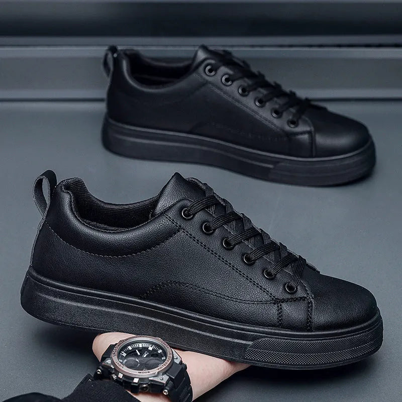 Men's low-top Korean-style casual sneakers in black on white colour with round toe and flat rubber sole.