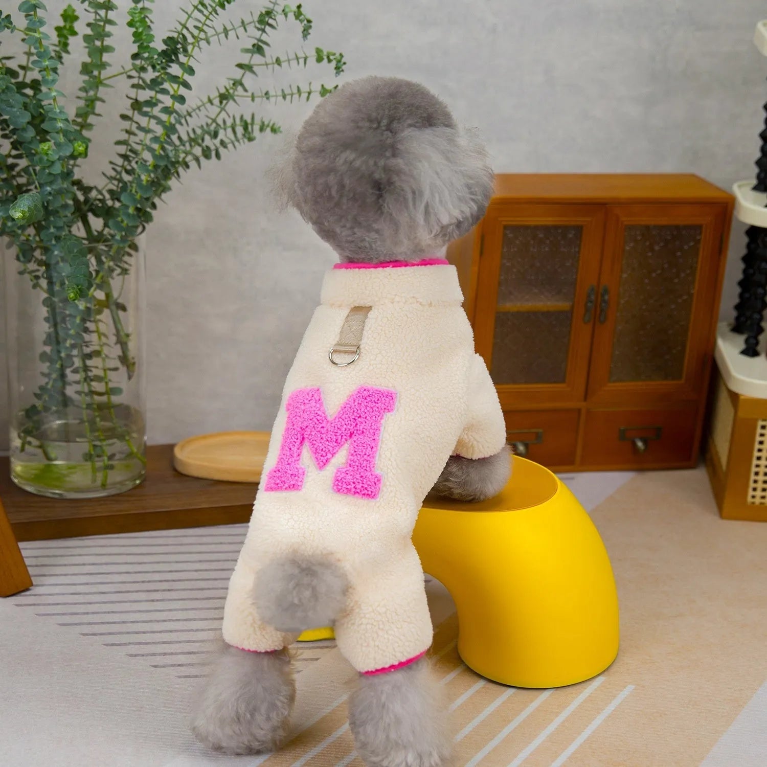 Four legs fluffy jacket pet clothing in beige colour on a small dog, polyester fabric, casual style.