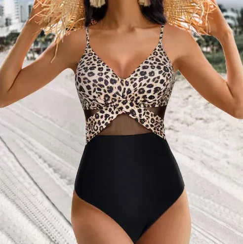 Halter-neck one-piece swimsuit with cross-strap back and mesh detail in solid colour