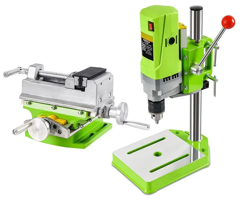Mini bench drill and milling machine with heavy-duty bench pliers on a workbench.