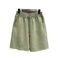 Men's loose-fit cotton shorts with a distressed finish in charcoal black, shown in a straight-leg style