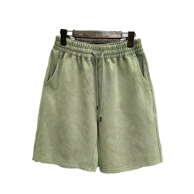 Men's loose-fit cotton shorts with a distressed finish in charcoal black, shown in a straight-leg style