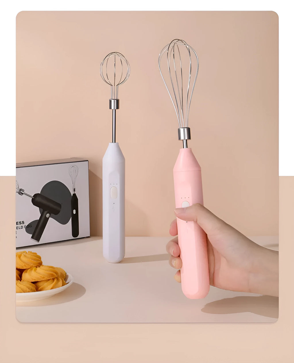Hand-held wireless electric whisk in black and pink, with straight handle and stainless steel whisk attachment