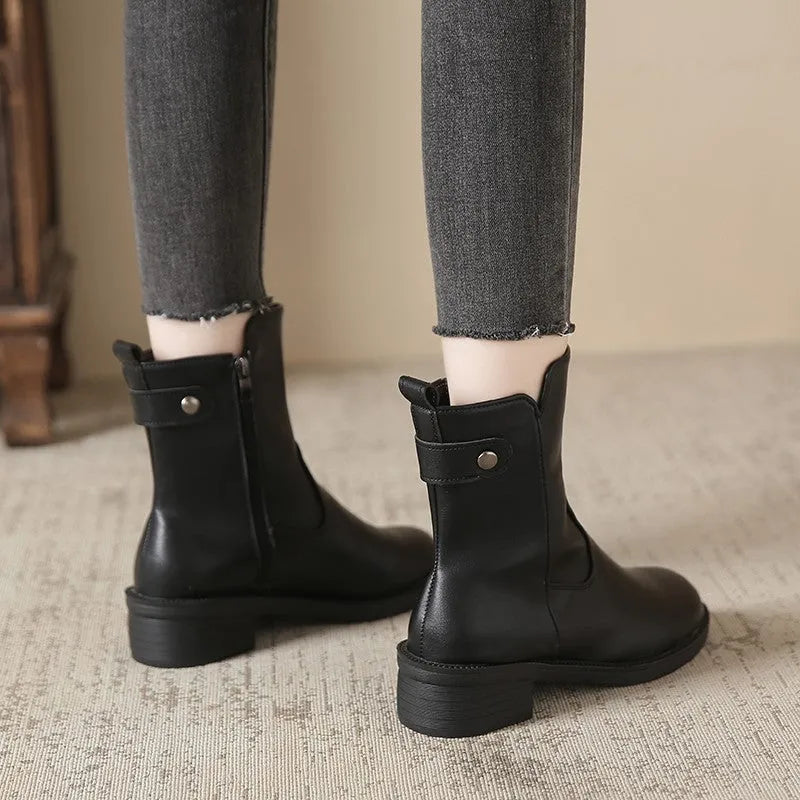 Black women's side zip boots with round toe and low rubber heel