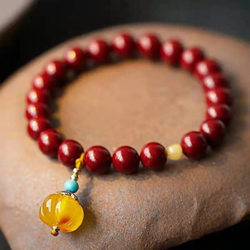 Close-up of a handcrafted wave-shaped cinnabar and copper bead bracelet in national style.