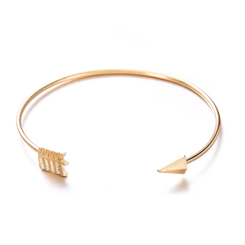 Gold Maili women's vintage cuff bracelet with arrow knot design.