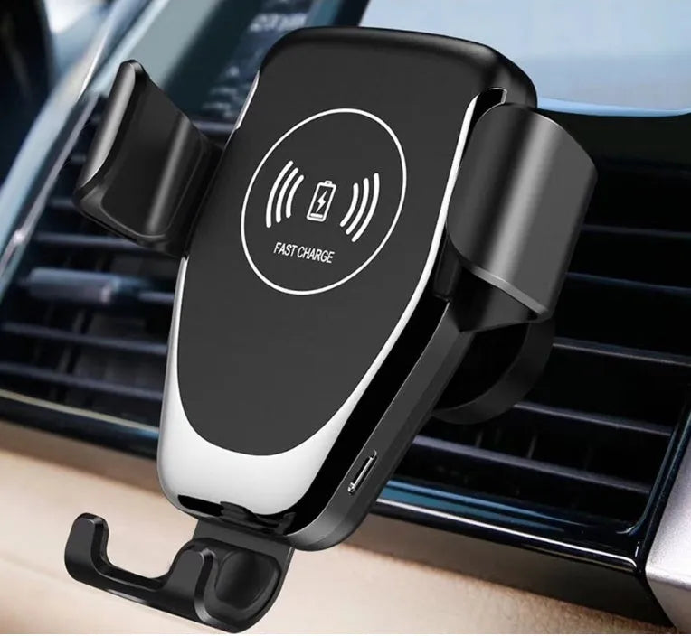 Black wireless car charger mounted on vehicle vent with iPhone secured in automatic clamping mechanism
