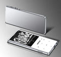 Portable black MP3 MP4 player with 2.4-inch touch screen showing music interface, placed next to wireless headphones.