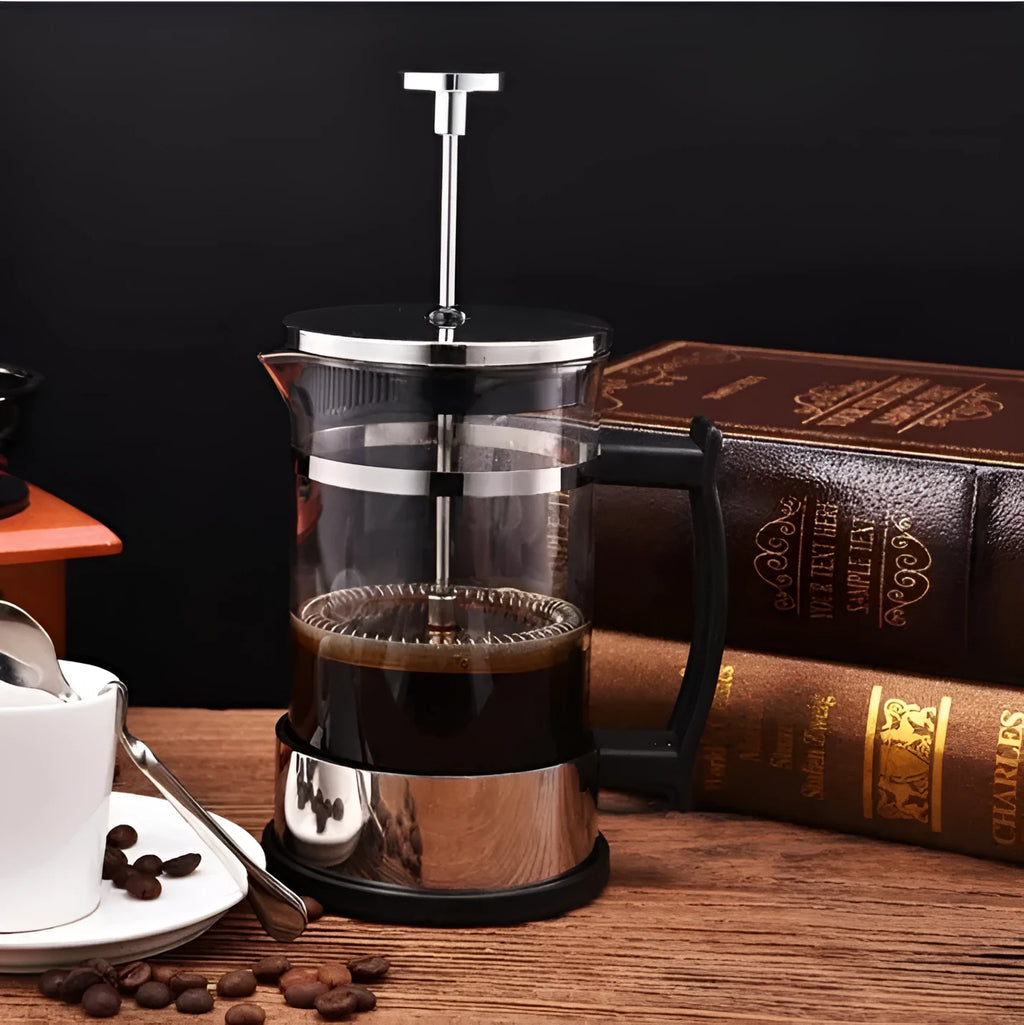 Small glass French press coffee maker with stainless steel plunger, shown with dimensions 10cm by 8cm by 17cm.