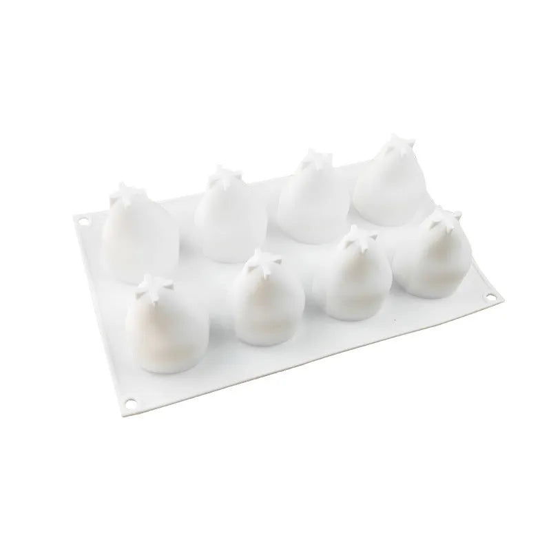 Silicone baking mould with six detailed pineapple and pine cone shaped cavities.