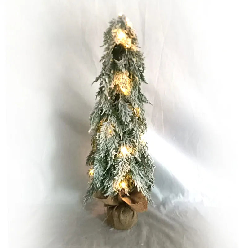 24-inch plastic artificial Christmas tree with snow sprayer and integrated lights on desktop