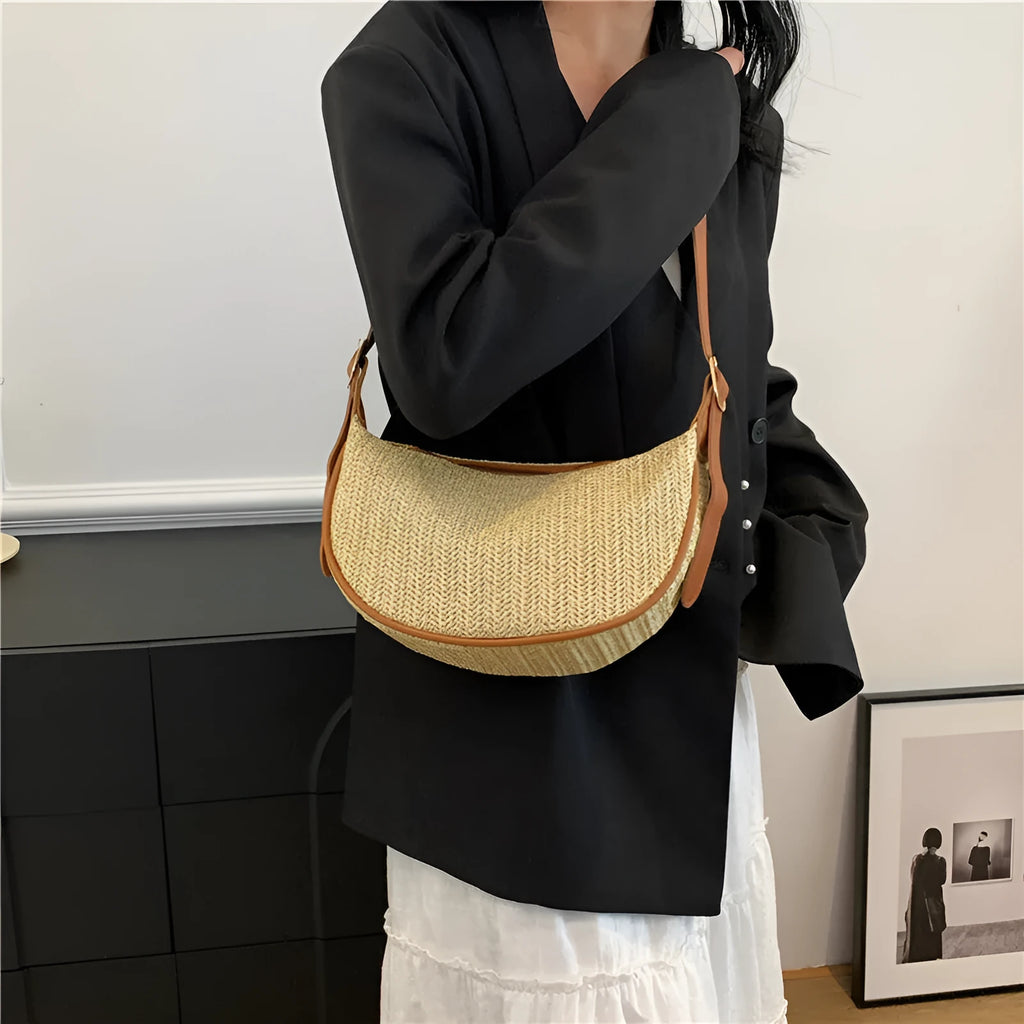 Women's straw woven crossbody bag showing woven texture and internal phone pocket
