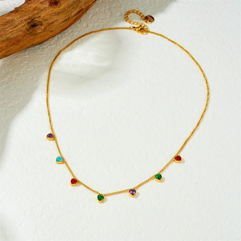 Gold heart pendant necklace on a stainless steel chain with adjustable length.