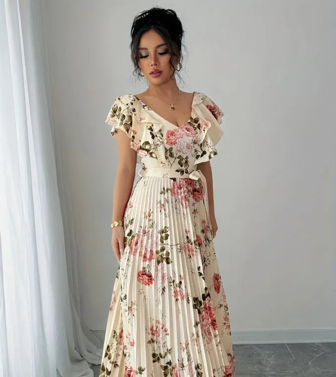 Apricot coloured floral print V-neck dress with ruffle sleeves and a flowing swing skirt.