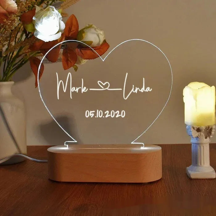 Custom acrylic LED night light displaying personal names and date, 20cm by 11.5cm, with USB cable.