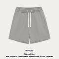 Loose-fit cotton denim shorts for baby or toddler in charcoal grey colour on a hanger.